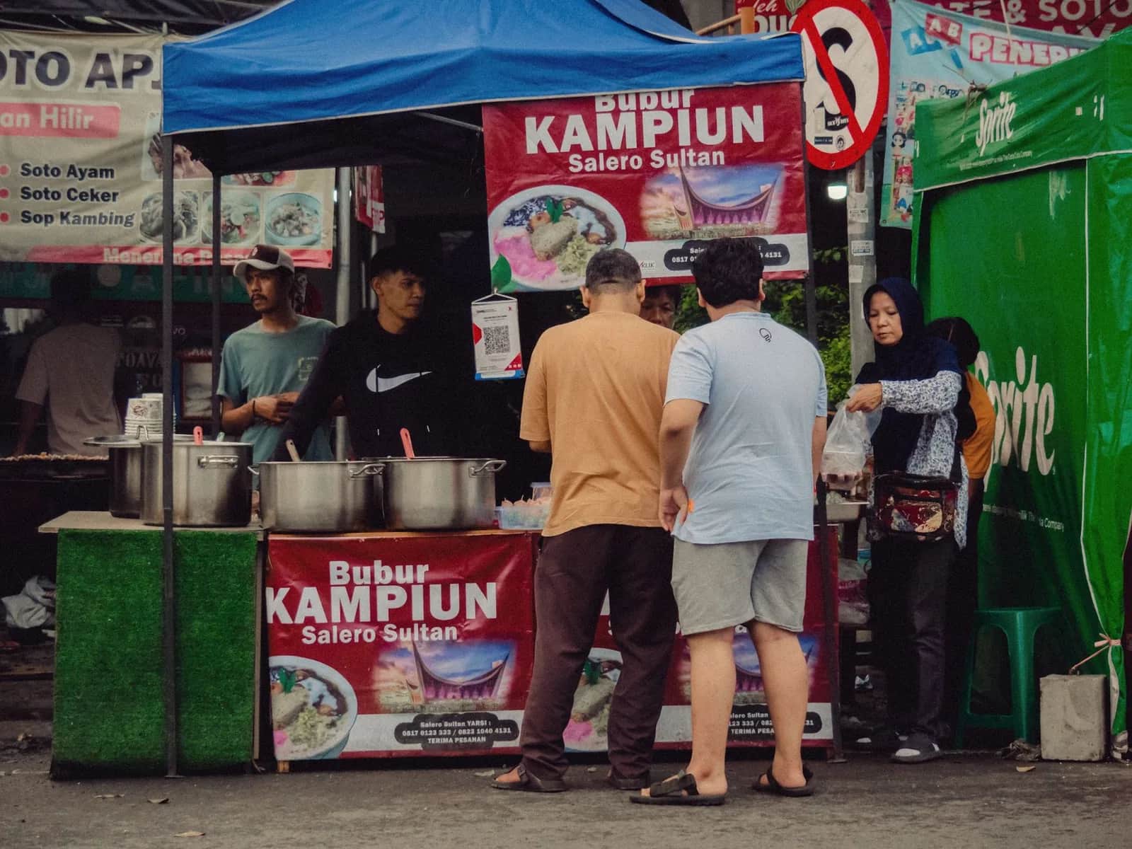 Stand de street food indonésien servant du bubur kampiun à des clients, Indonésie