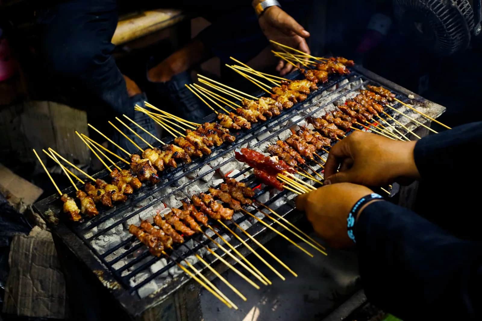 Brochettes de satay grillées sur un stand de rue le soir à Jakarta