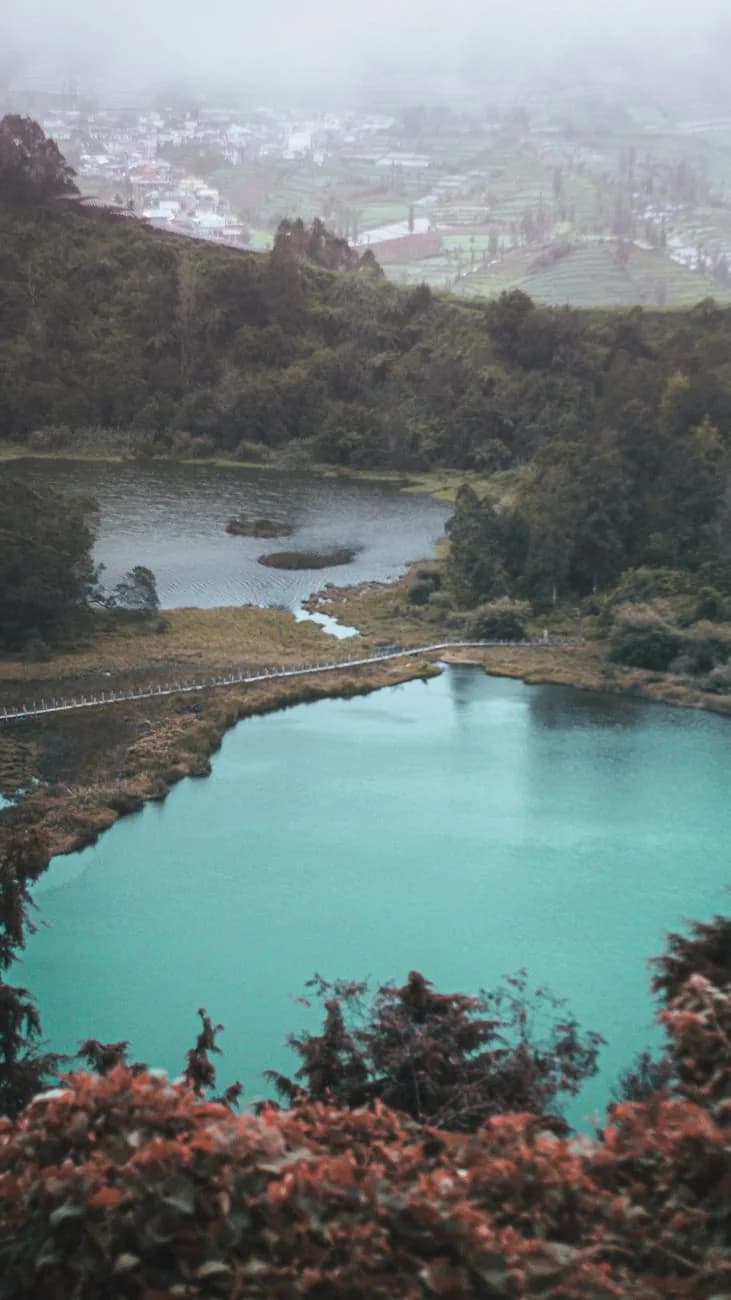Le lac de Telaga Warna aux eaux turquoise sous la brume du plateau de Dieng, Java central