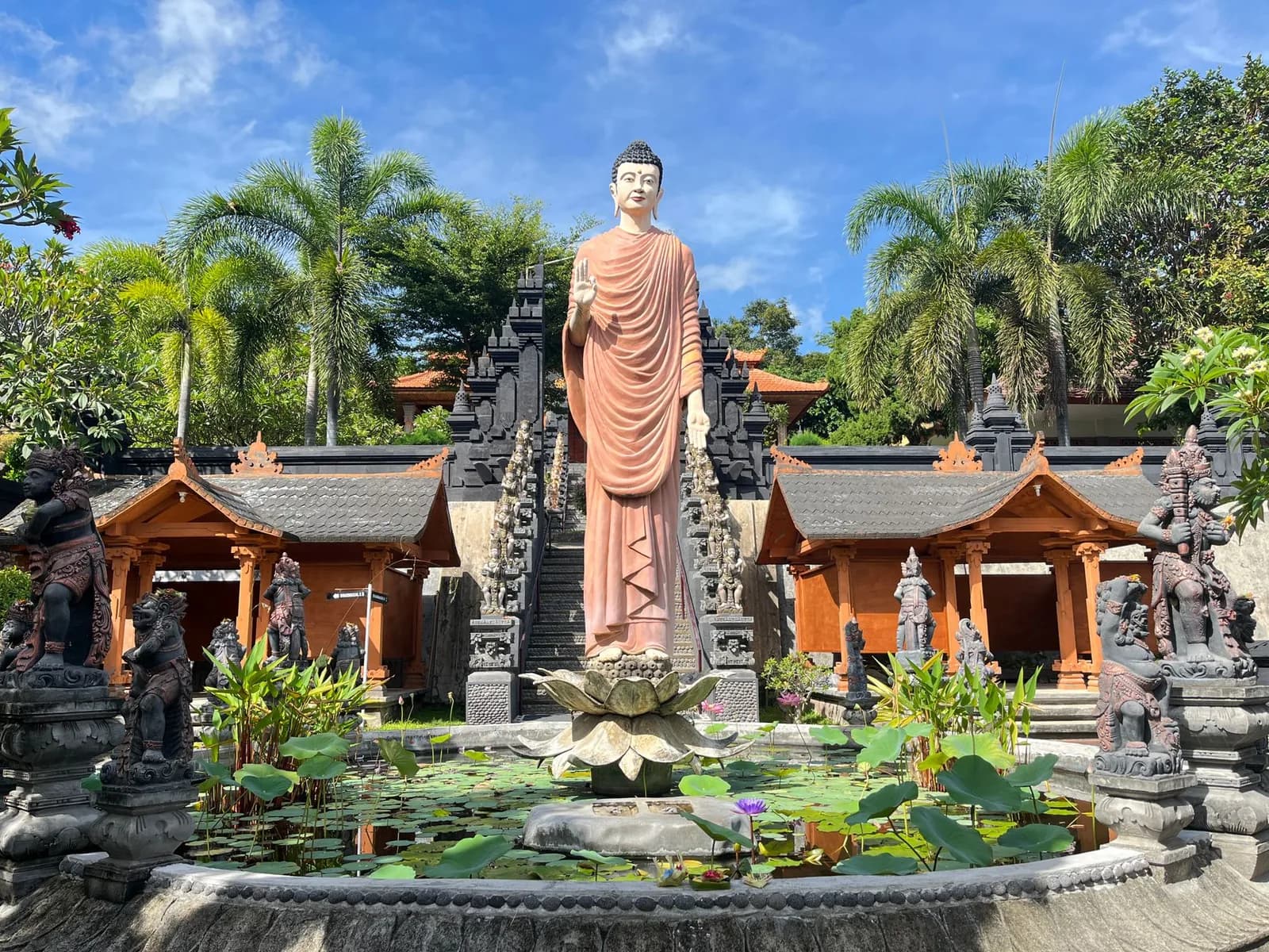 Grand bouddha doré debout sur un socle de lotus au milieu d'un bassin, monastère Brahmavihara-Arama à Banjar, nord de Bali